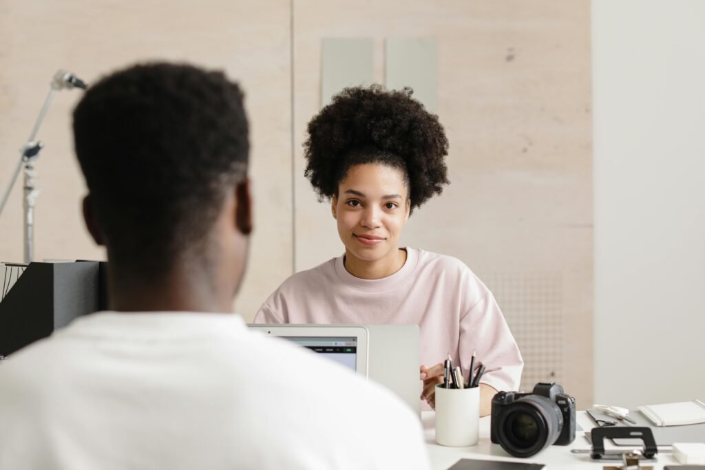 Two colleagues working together, engaging in a collaborative workplace environment.